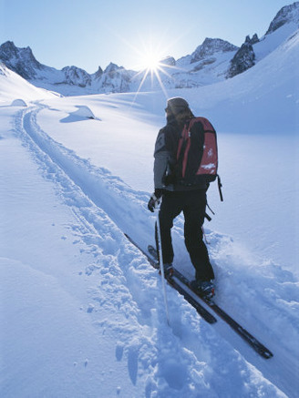 A Woman Skiing in the Selkirk Mountains, British Columbia, Canada