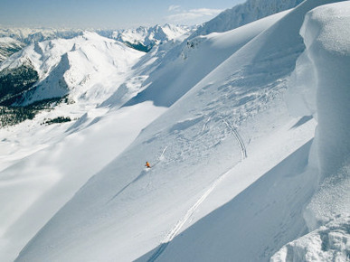 A Man Skiing the Dogtooth Range