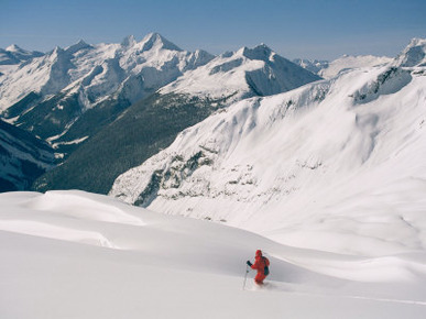 A Man Skiing in Snow Drifts in a Wintry Mountain Landscape