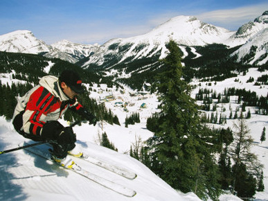 Man Skiing Along a Slope Above a Valley