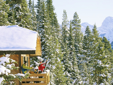 Skiers on Balcony of Ski Lodge Prepare for Skiing