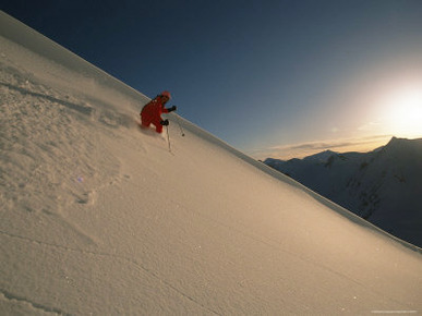 A Man Downhill Skiing at Twilight on Mount Bonney