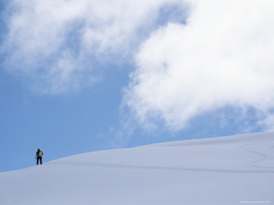 Backcountry Skiing over a Ridge in British Columbia