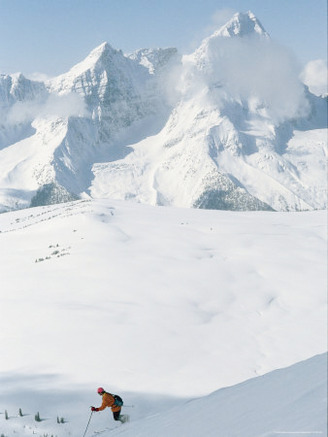 A Man Skiing on Copperstain Mountain.Selkirk Mountains and Mount Sir Donald are in the Background