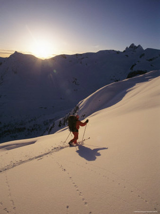 A Man Skiing the Selkirk Mountains at Twilight