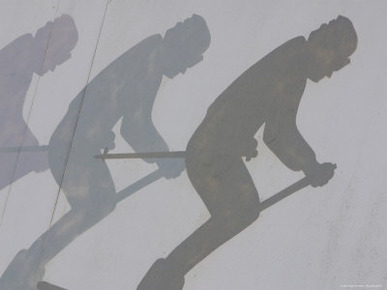 A Gray Wall with Faded Black Images of a Man Skiing