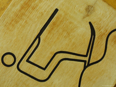 Close-up of a Brown Sign with an Engraved Image of a Person Skiing