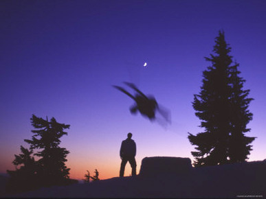 Silhouette of Two Skiers Skiing