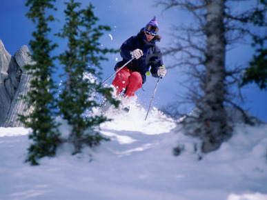 Young Woman Skiing Down a Hill