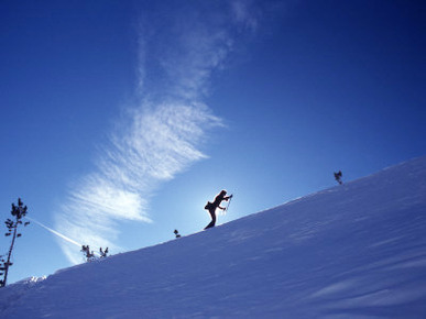 Silhouette of a Woman Cross Country Skiing Up a Snowy Slope, Mount Rose, Nevada, United States