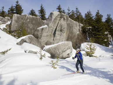 Woman Cross-Country Skiing Past Big Rocks in West Virginia