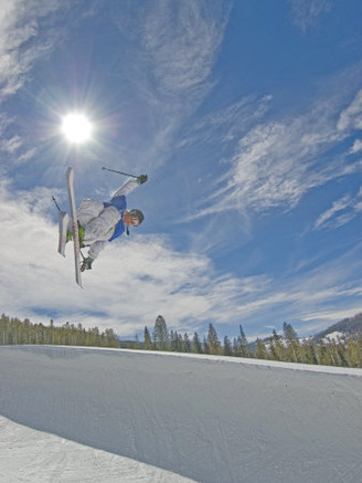 Skiing Aerial Maneuvers and Flips in Half Pipe in a Terrain Park